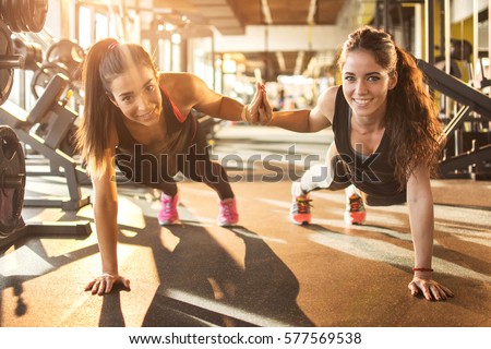 Sporty women working out together at gym.