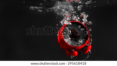Red Retro Alarm Clock In Water
