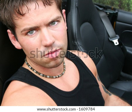 Buckle Up, handsome young Man in Sports Car