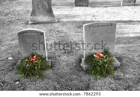 Together Always, atmospheric desaturated Image of Husband and Wife graves with wording removed except for In Loving Memory of and together. With Christmas Wreaths  on a frosty bright December Morning.