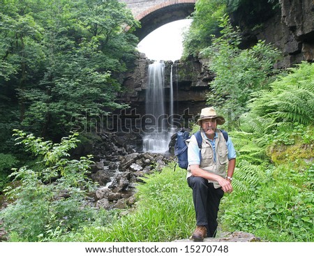 Explorer in the Garden of Eden, with spectacular fiftey feet high  Ashgill  Force in background located near to the small isolated market town of Alston in Cumbria\'s Eden district