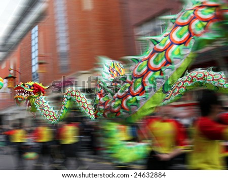 Chinese New Year Parade with Motion Blur as the Dragon speeds and twirls through City Streets to bring in year of the Ox