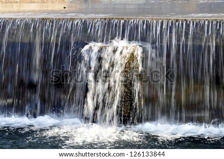 The water falls down a weir, and keep the water clean