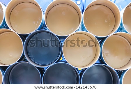 gallon chemical drums in a storage yard awaiting recycling
