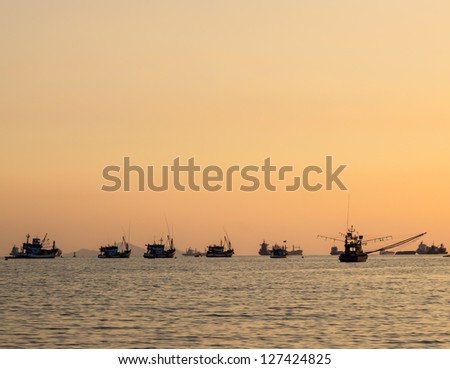 Thai fishing boat used as a vehicle for finding fish in the sea.at sunset