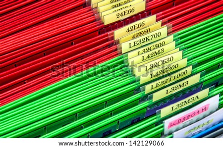 Abstract background image of colorful hanging file folders in drawer. Macro with with extremely shallow dof. Selective focus in front edges of files.