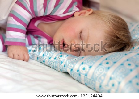 baby girl sleeping on a pillow
