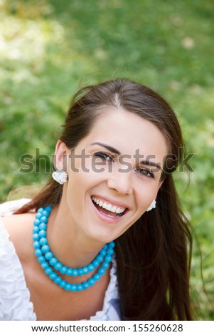 outdoor portrait of young woman laughing looking at camera