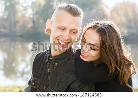 young male and female sitting talking smiling having good time