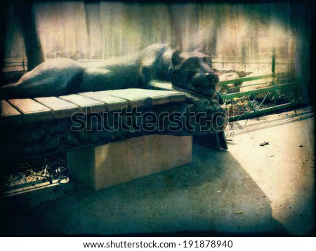 Decorative bench with gypsum panther, vintage background.