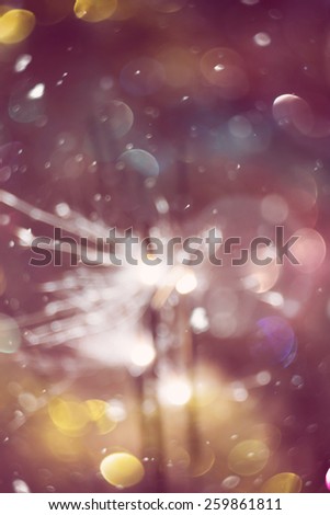Holiday background with bright bengal fire and colorful bokeh lights.