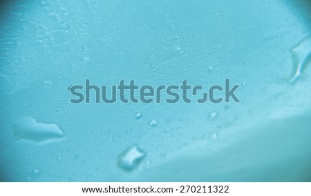 Extremely close up of wet surface, blue toning background.