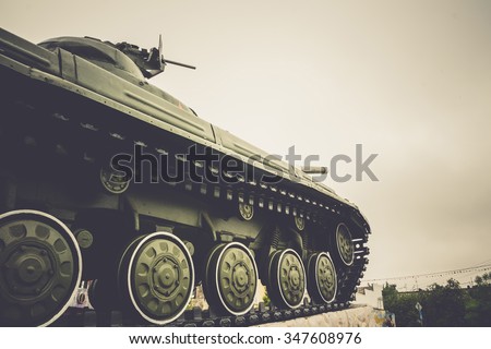 Vintage military tank in the city, close up background.