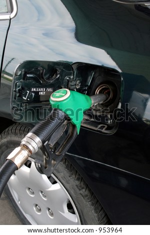 petrol pump filling car up with fuel