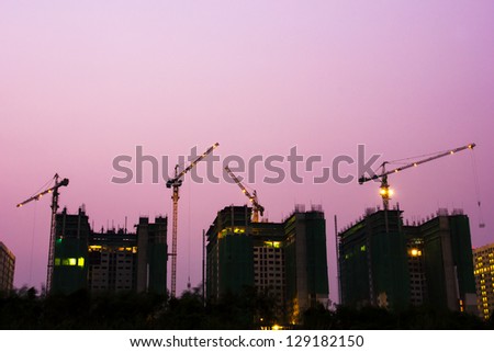 Construction of buildings in the capital, construction cranes and building silhouettes with Twilight