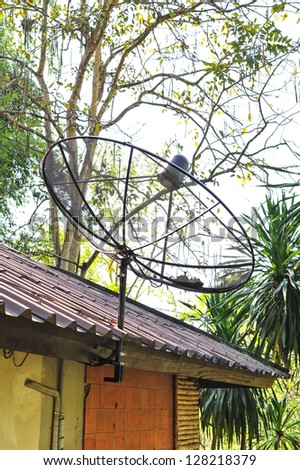 The satellite dish on roof edge
