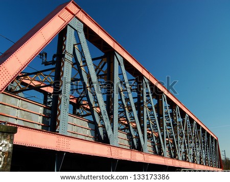 Steel girder railway bridge crossing main west coast line next to Grand Union Canal, London, England, UK