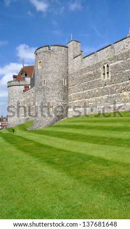 WINDSOR CASTLE - MAY 5: Windsor Castle in the county of Berkshire, England, UK. South-west stone battlement wall and grass banking on May 5, 2013.