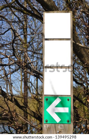 Square blank signs and arrow on wooden post for your design or advertisement.