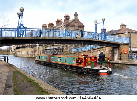 LONDON - APRIL 14. Narrow boat sailing east along England\'s Grand Union Canal which streaches 137 miles from London to Birmingham with 166 locks, on April 14, 2013 in west London, UK.