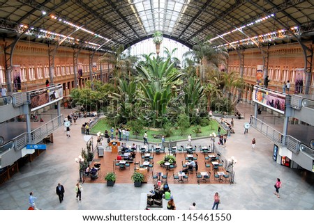 MADRID - JUNE 9. The original 19th century Atocha Railway Station is now a concourse with shops, cafes and a botanical garden forming the entrance to the new station, June 9, 2007 in Madrid, Spain.