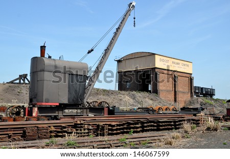 DIDCOT, UK - JULY 13. A vintage five-ton shunting crane, coaling stage, water tank, railway track, locomotive wheels and components on July 13, 2013, located at Didcot Railway Centre, Oxfordshire, UK.