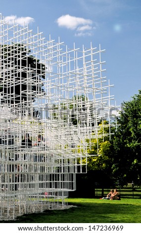 LONDON - JUNE 29. The annual competition to design the Serpentine Gallery summer pavilion is won by Sou Fujimoto with a delicate stepped structure; June 29, 2013 in Kensington Gardens, London, UK.