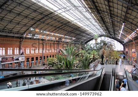 MADRID - JUNE 9. The original 19th century Atocha Railway Station is now a concourse with shops, cafes and a botanical garden forming the entrance to the new station; June 9, 2007 in Madrid, Spain