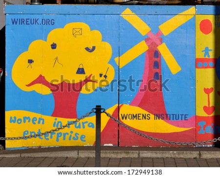 IPSWICH, UK - JANUARY 11. Temporary building site hoarding on January 11, 2014 decorated to promote two British women\'s rural community networking organisations in Ipswich, Suffolk, England, UK.
