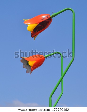 HASTINGS, UK - JUNE 8. Large decorative painted artificial metal flowers in a children\'s entertainment area on June 8, 2013, located by the beachfront at Hastings, East Sussex, England, UK.