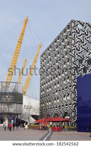 LONDON - MARCH 8. Ravensbourne is a university college for digital media and design in a tessellated clad building next to the yellow structure of the O2 Arena on March 8, 2014 in Greenwich, London.