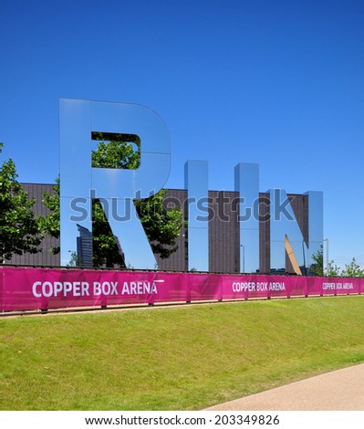 LONDON - JULY 3. Monica Bonvicini\'s 29.5 feet (9 metre) art installation of three glass letters RUN on July 3, 2014 by the Copper Box Arena in the Queen Elizabeth Olympic Park, Stratford, London.