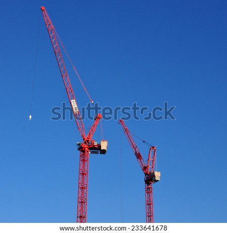 LONDON - OCTOBER 27. Two red Wolff luffing jib cranes on building site on October 27, 2014 at Stratford in the Borough of Newham, east London, UK.