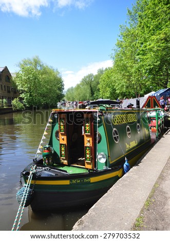 RICKMANSWORTH, UK - MAY 16, 2015. A narrow boat moors along the Grand Union Canal for the annual town festival at Rickmansworth, a small town in the county of Hertfordshire, England, UK.