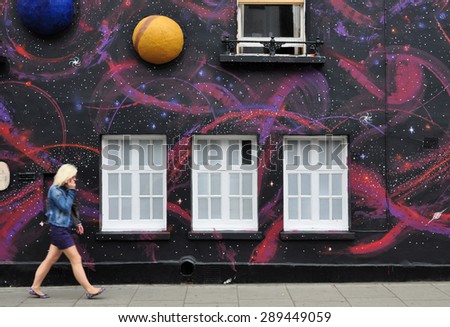 LONDON - JUNE 20, 2015. Temporary painted mural with appied planets, by artist Steve Stephenson on the facade of The Chelsea Arts Club in the Royal Borough of Kensington and Chelsea, London, UK.