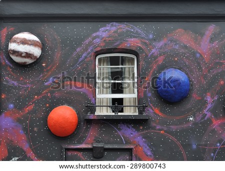 LONDON - JUNE 20, 2015. Temporary painted mural with applied model planets by artist Steve Stephenson on the facade of The Chelsea Arts Club in the Royal Borough of Kensington and Chelsea, London.