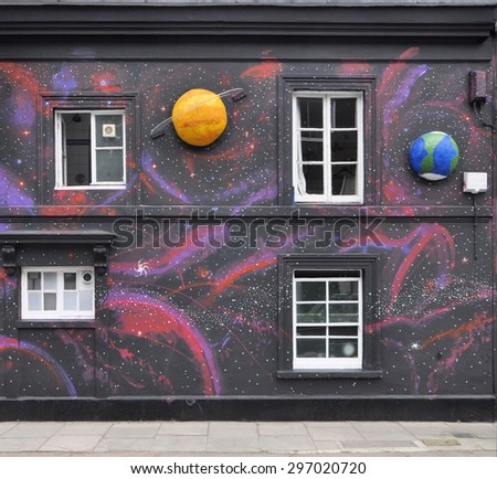 LONDON - JUNE 20, 2015. A temporary painted mural with appied model planets by artist Steve Stephenson on the facade of The Chelsea Arts Club in the Royal Borough of Kensington and Chelsea, London.