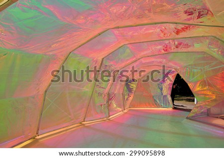 LONDON - JULY 18, 2015. Interior of the summer Serpentine Pavilion designed by Salgas Cano employing coloured, translucent and iridescent materials with varied lighting in Kensington Gardens, London.