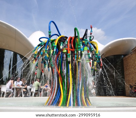 LONDON - JULY 18, 2015. Fountain is a playful interpretation of a water feature using garden hoses by French artist Bertrand Lavier at The Magazine restaurant in Kensington Gardens, London, UK.