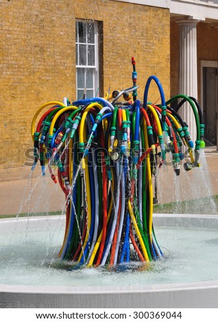LONDON - JULY 18, 2015. The Fountain is a playful interpretation of a water feature using garden hoses by French artist Bertrand Lavier at The Magazine restaurant in Kensington Gardens, London, UK.