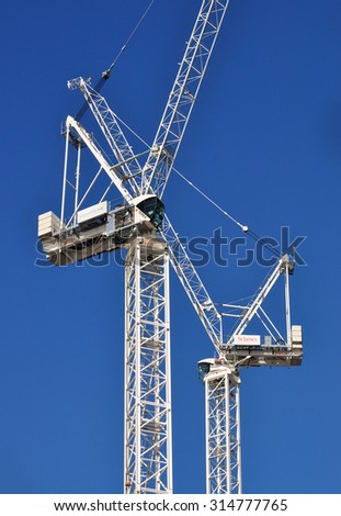 LONDON - SEPTEMBER 6, 2015. A pair of building construction cranes in the Vauxhall district of London, UK.