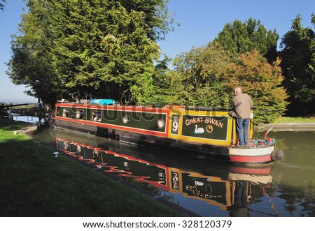 DEVIZES, UK - SEPTEMBER, 26, 2015. A narrow boat travels along the Kennet and Avon Canal at Devizes, a small town in the county of Wiltshire, England, UK.