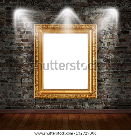 Gold frame on brick wall in grunge room