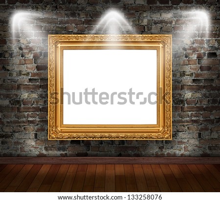 Gold frame on brick wall in grunge room