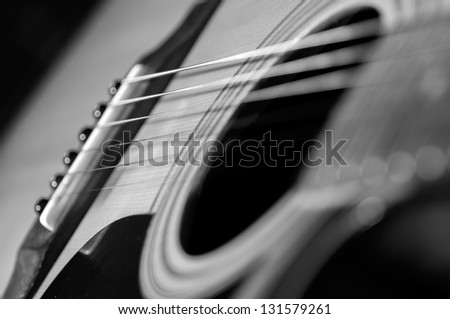 Acoustic Guitar with very shallow depth of field, focus on strings. Black & White