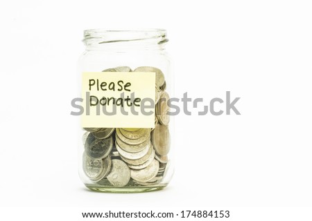 Isolated coins in jar with Please donate label