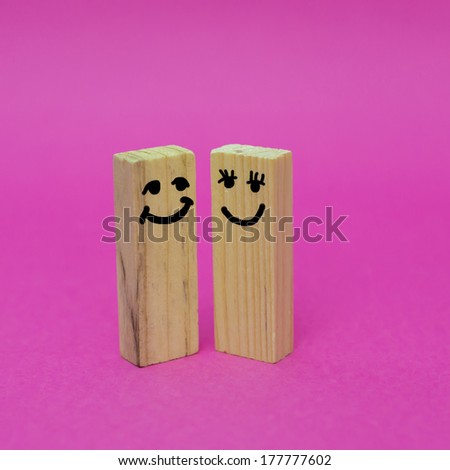 Painted happy wooden block meet each other