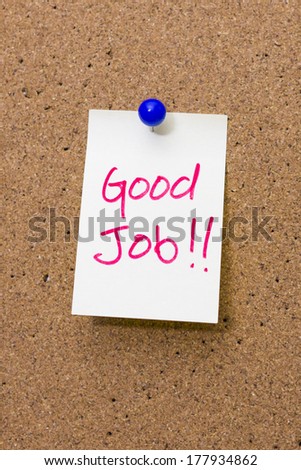 Paper note with word Good Job pinned on cork board