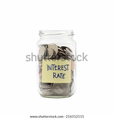 Isolated coins in jar with interest rate label - financial concept