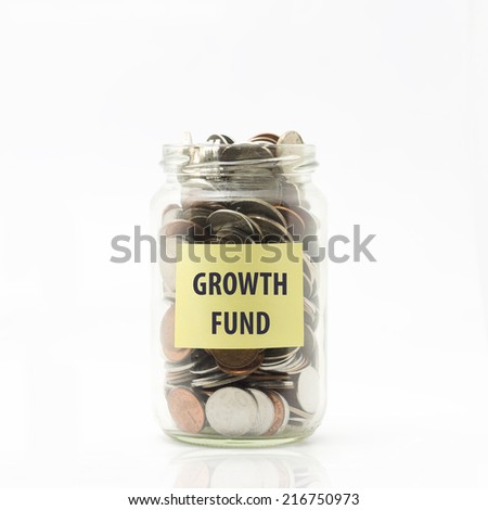 Isolated coins in jar with growth fund label - financial concept
